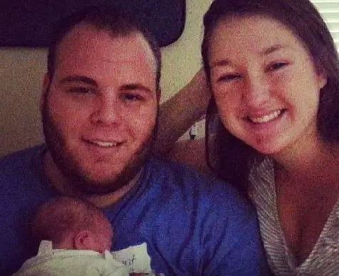 August Anna Brooks with her husband and newly born baby
